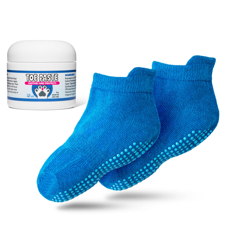 Blue socks with textured sole and a jar of toe paste on a white background